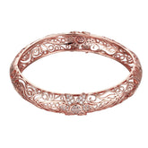 Stunning rose gold bangle adorned with detailed filigree flowers and shimmering cubic zirconia stones.